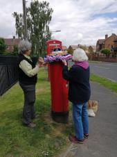 Yvonne and Dorothy decorating the post box for the Platinum Jubilee